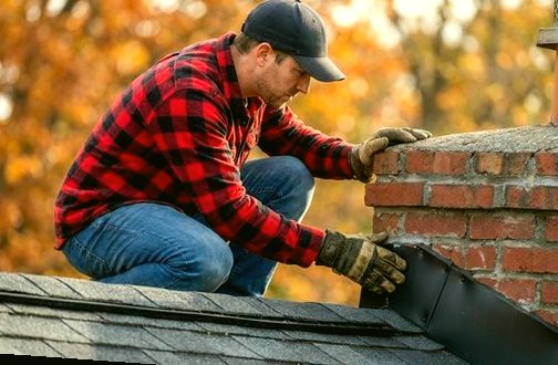 Mason taking the measure of a weathered brick stack